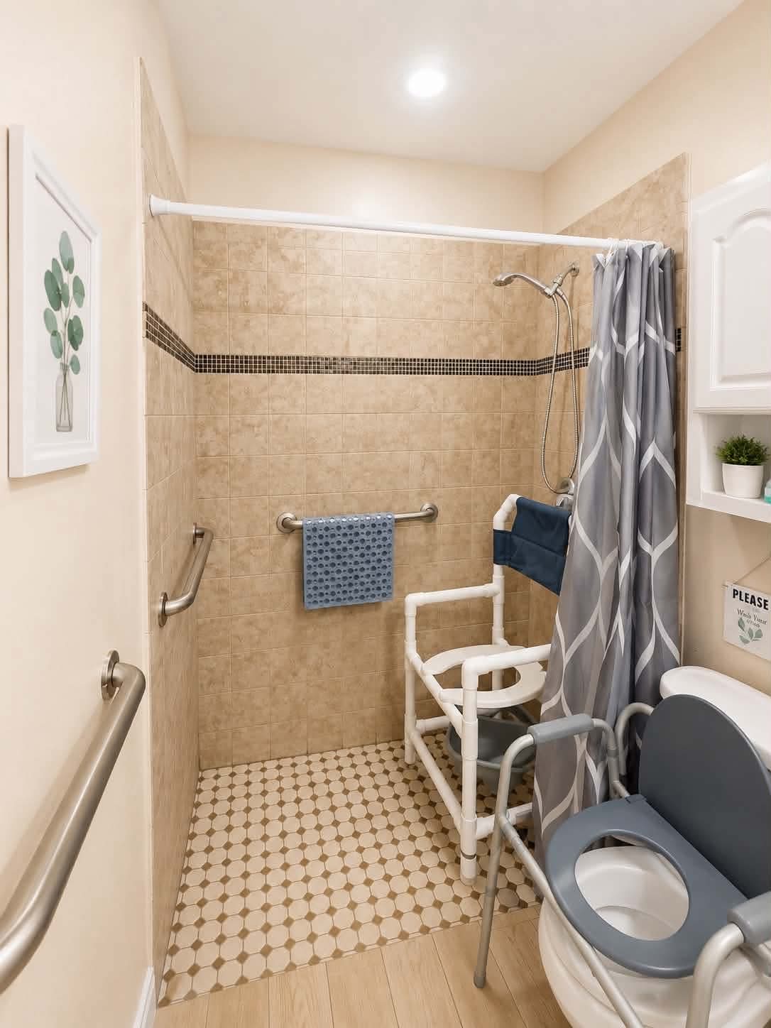 An ADA-friendly bathroom at Tessa Place 2 with multiple grab bars, a walk-in shower with a chair, and a raised toilet.